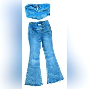 Flare denim jean with v shaped top. Silver buckle on denim top. Small.​​…​